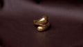 Gold ring on a dark fabric background