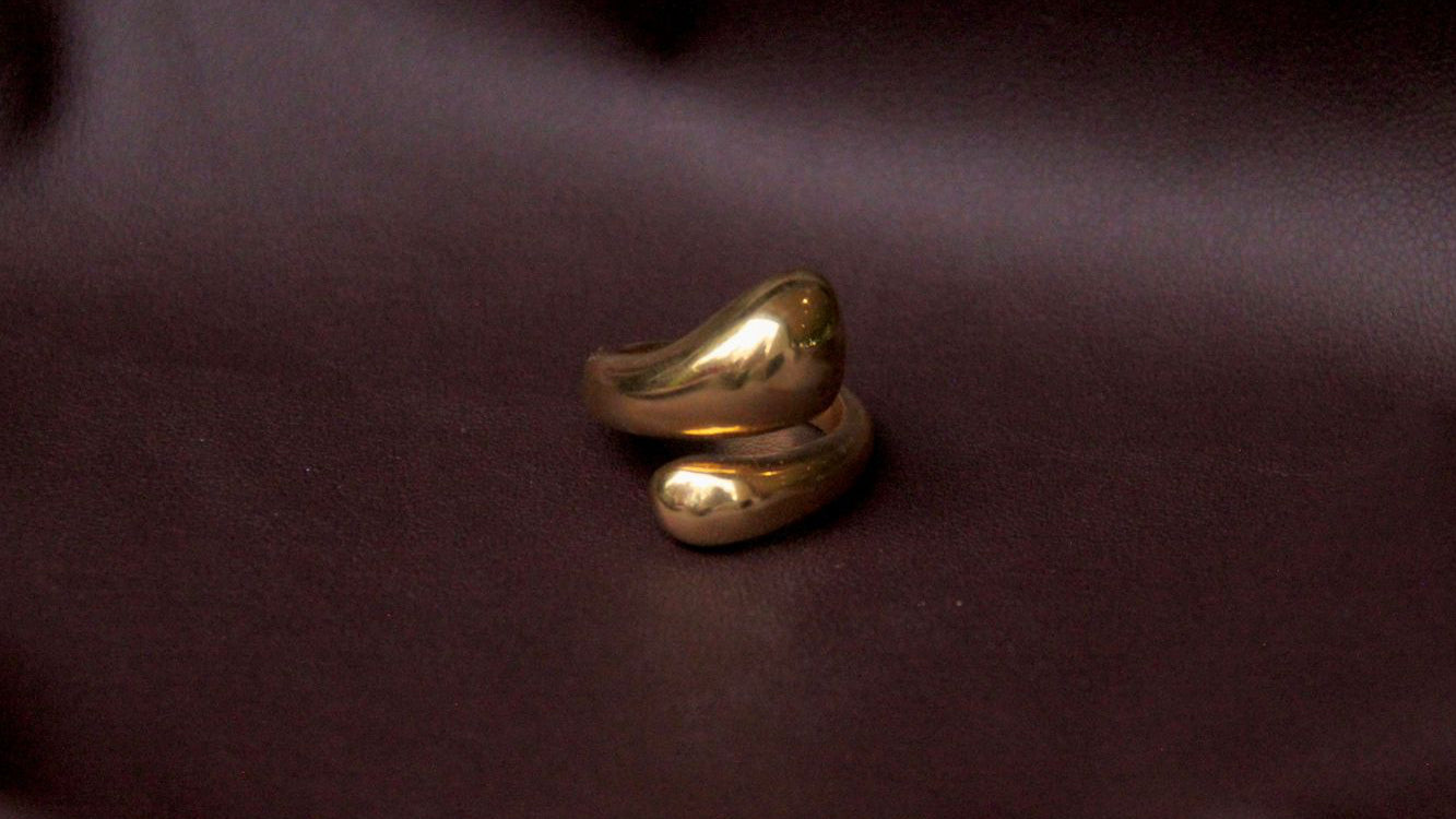 Gold ring on a dark fabric background